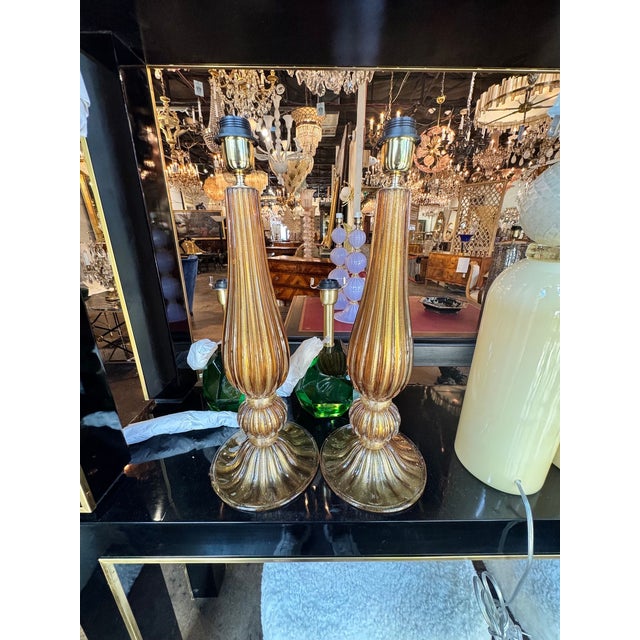 This product is a pair of elegant Murano glass lamps featuring a beautiful amber and gold color combination. Made with...