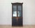 Made in Sweden in the early nineteenth century, around 1820, this tall bookcase has adjustable shelves, a repainted black...