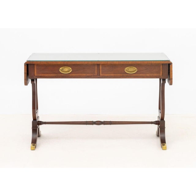 Baker Furniture Mahogany Sofa Table, with glass top above two drawers and lyre form legs with brass mounted paw feet,...