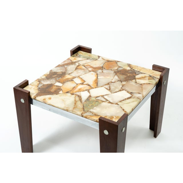 A Joaquin Moll-style side table with an onyx/marble mosaic top, embodying the Mid-Century Modern design typical of the...