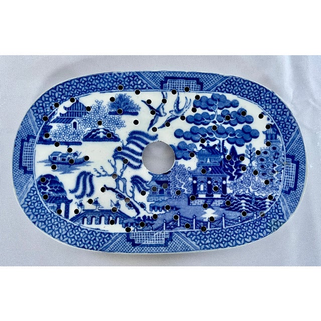 An exceptional 19th-century English blue and white transferware pottery platter drainer (also known as a mazarin). This...