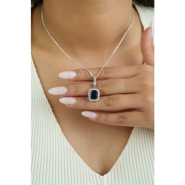 This halo pendant showcases a 2.57 carat blue sapphire set in 14k white gold. The sapphire measuring approximately 9.9 x...