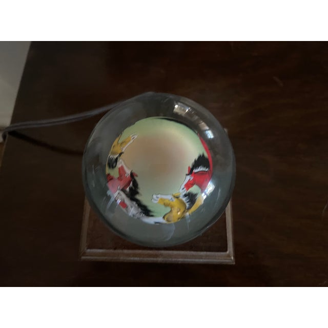 This beautiful Chinese painting on a globe depicts the running of horses. TThe globe is from China and is an antique item...