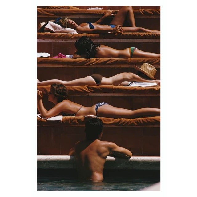 Eye Of The Beholder 1974 A man contemplates the sunbathers by a swimming pool in Capri, Italy, August 1974. Slim Aarons...