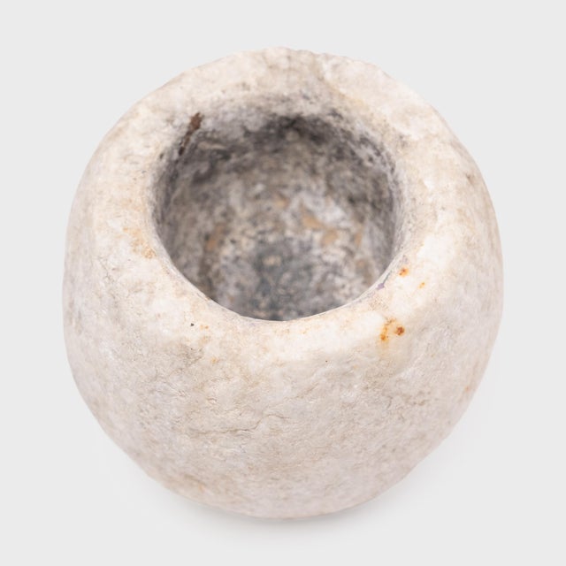 Hand-carved from a single block of marble, this original stone vessel is an antique Chinese mortar once used to grind...