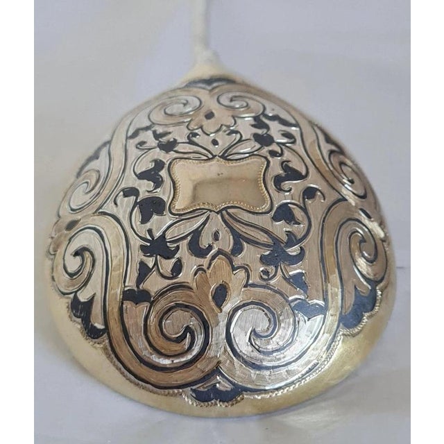A fine antique Russian silver-gilt spoon dating to 1865, crafted in Moscow and distinguished by intricate traditional...