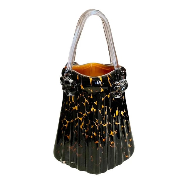 Hand-blown Manorisms glass purse from the 20th Century produced by a decorative arts company in China for the American...