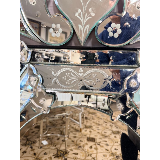 An elegant Venetian-style wall mirror featuring a beautifully shaped octagonal form and an elaborate scrolling crest. This...