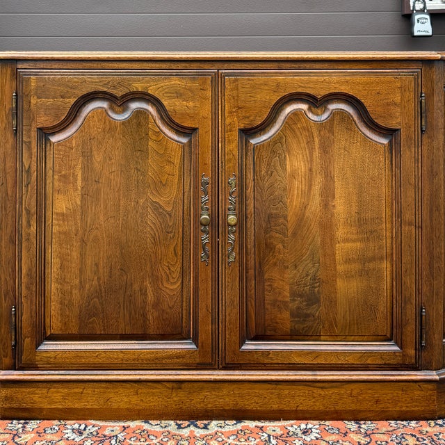 A vintage Davis Cabinet Co. Traditional Georgian solid walnut buffet consisting of a two door cabinet with a silverware...