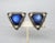 This is part of Chairish’s Costume Jewelry assortment. 1950s triangular silvertone bumpy texture with cabochon blue resin...