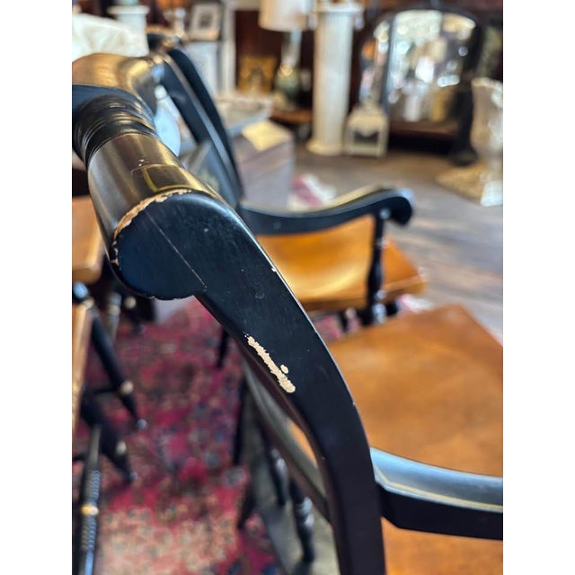 Classic wood dining chairs with stencil over black backs and brown wood seats. 2 armchairs and 2 side chairs. Minor...