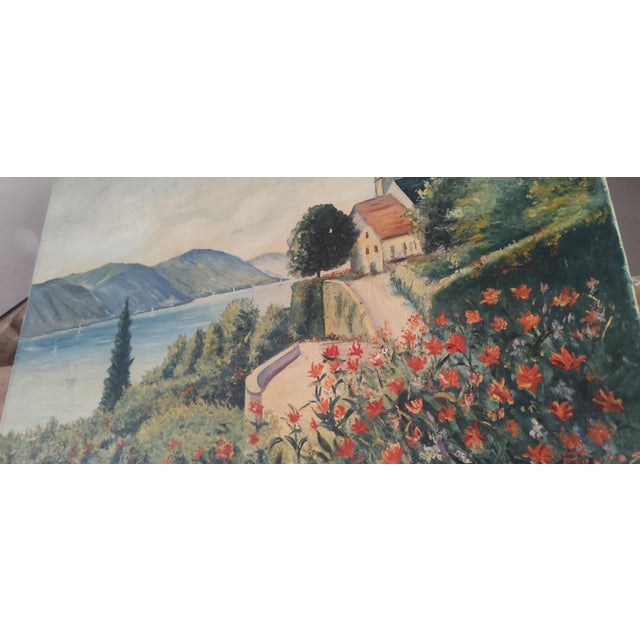 A charming vintage oil painting depicting a peaceful European lakeside village scene with mountains, sailing boats and a...
