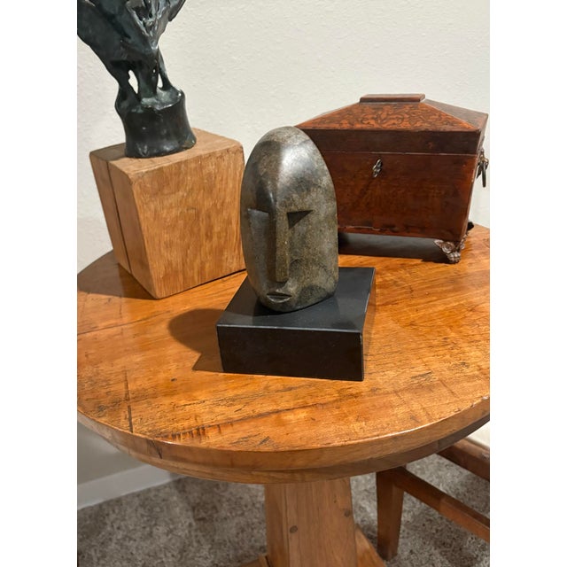 Stone carving of a Hemba Monkey Mask, also known as a “Soko Mutu” or “So’O” head. Originating from the Hemba people of the...