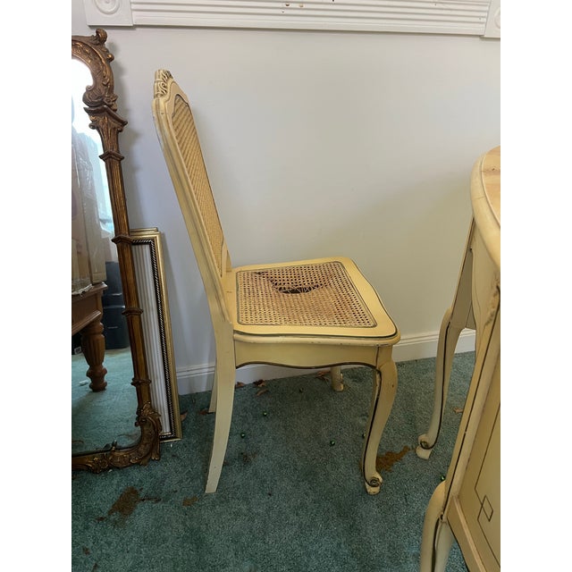 This chair is an antique French Provincial Louis XVI style. It features a distinctive cane back and seat and Cabriole...