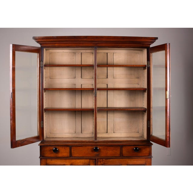 Found in England, this mahogany cupboard dates from the 1870s. Cabinet has locking glazed doors on the top with three...