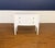 This is a White Serpentine Two Drawer Accent Chest. We believe it is made by Highland House, but we are not positive. It...