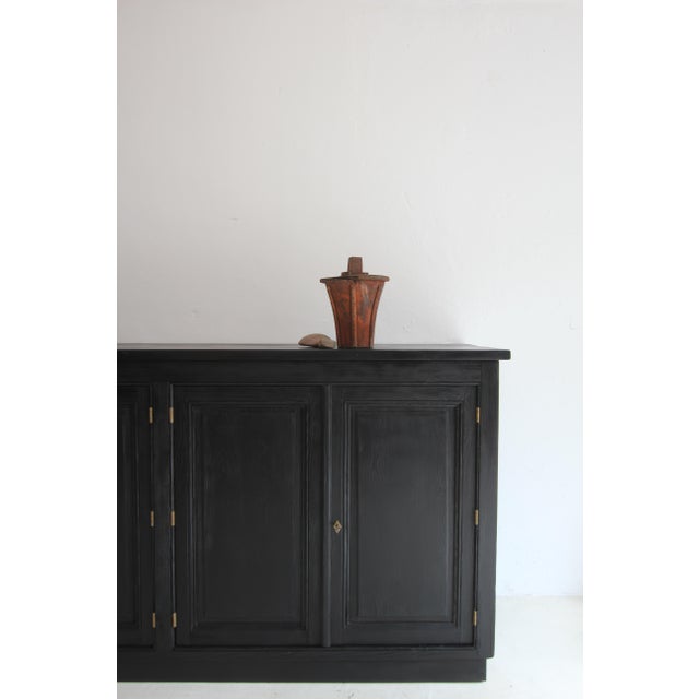 A early 20th century wooden casting pattern. Probably as part of a drive shaft. Shaft in the shape of an inverted blunted...