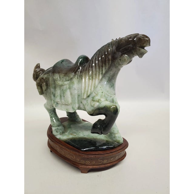 Beautiful vintage hand-carved stone horse on a carved wood stand inlaid with a brass cloud design. Very weighty. Adds a...