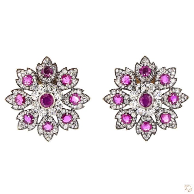 This set of earrings centers on a 5.67-carat diamond in a round brilliant cut for lively, classic sparkle. It is framed by...