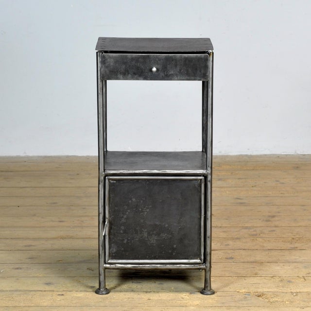 This iron nightstand, circa 1920, originated from a hospital. The old paint has been completely stripped, polished, and...