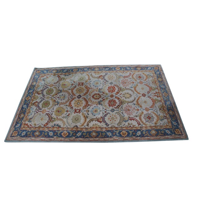 Woolmark Hand-Tufted Wool Indo-Persian "Eva" Rug in beige and blue is a premium, traditional-style area rug renowned for...