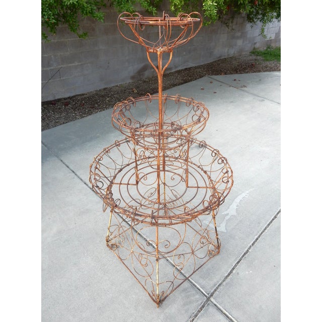 Antique wrought iron and wire 3-tier garden plant pot stand. Hand crafted and created using thick wire over an iron frame....