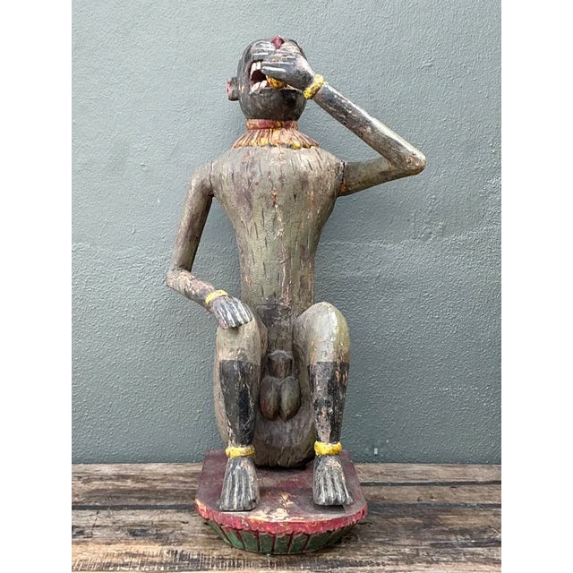 This vintage painted wood monkey sculpture is a charming example of mid-20th-century folk art, full of personality and...