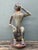 This vintage painted wood monkey sculpture is a charming example of mid-20th-century folk art, full of personality and...