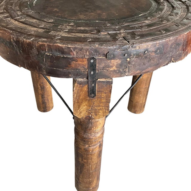Vintage Indonesian Wagon Wheel Repurposed into a stunning Accent Side Table Features Rustic Metal Bands around the Table...