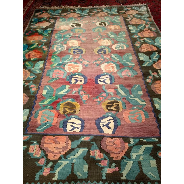 A vivid and visually striking vintage Karabagh kilim from the early 20th century, this room-size flat weave kilim is a...