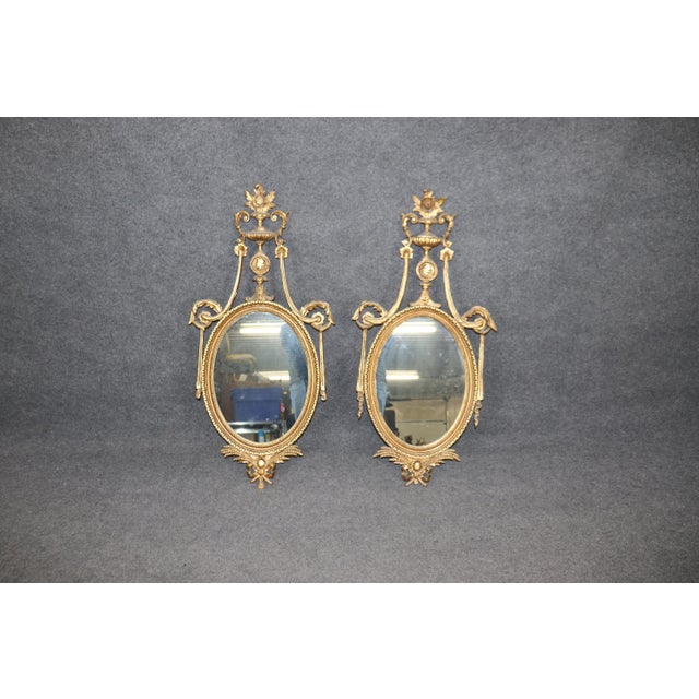 This is a superb and unique pair of mirrors. Designed as a husband and wife pair, there is a carved portrait of the...