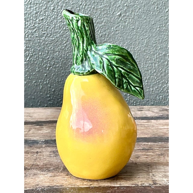 This delightful vintage ceramic pitcher is a masterful example of trompe l'oeil botanical design, expertly crafted to...