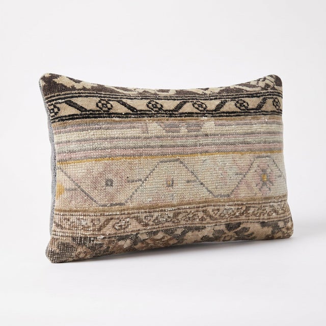 This 16'' x 24'' pillow cover was made from an authentic Turkish rug — faded Oushak bands in taupe, blush and dark brown....