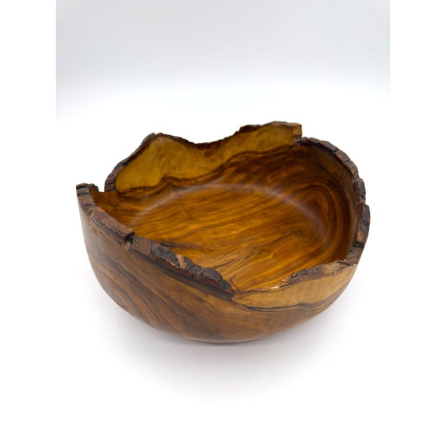 A beautifully hand-carved olive wood bowl, handmade in Peru and finished with a natural live edge that highlights the...
