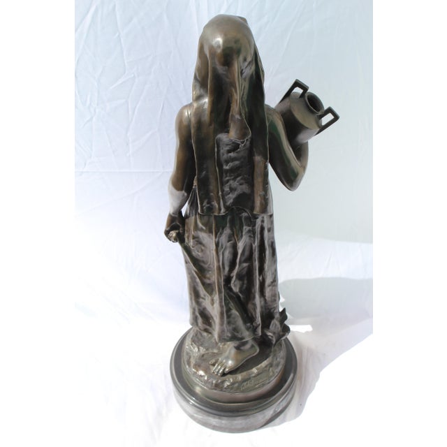 Great looking lady figurine carrying a water Jug. Multi-patinas and mounted on a special marble base. Heavy casting 29"...