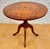 Beautiful 20th-century round side table featuring an ornate marquetry top with floral and geometric inlay work. The...