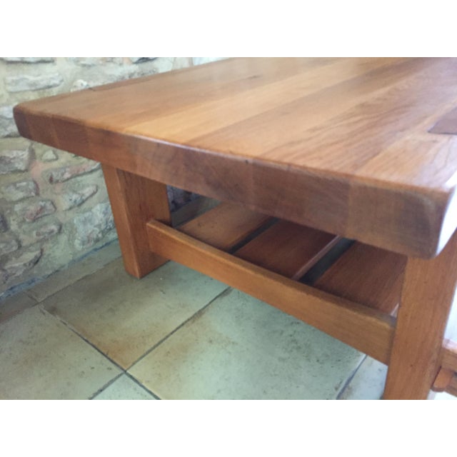 PIERRE CHAPO, Coffee table in solid elm, rectangular in shape, suspended, sliding drawer, opening on both sides. This...