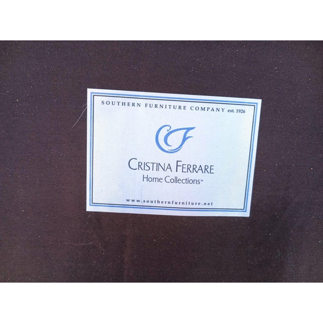 Crafted with a richly carved wooden frame and a luxurious, tufted brown leather back, this loveseat exudes elegance and...