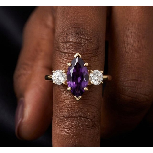 Capture timeless sophistication with this exquisite three-stone ring, This design highlights a striking marquise-cut...