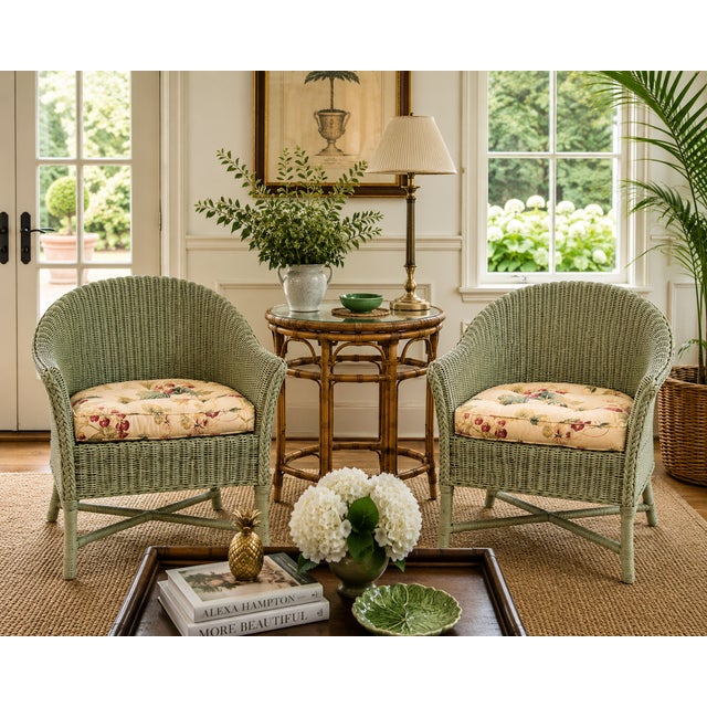 A delightful pair of vintage wicker tub armchairs finished in a softly weathered sage green paint with the warm natural...