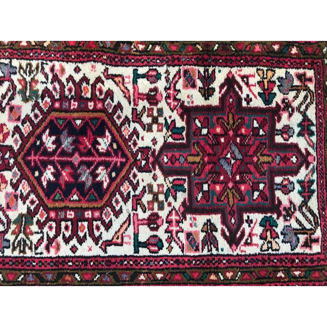 Nice 20th century runner with a geometric Heriz style design and nice colors with white field, pink, purple, yellow, green...