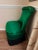 This striking piece is a Hollywood Regency style "Draper" slipper chair featuring a bold emerald green satin finish and a...