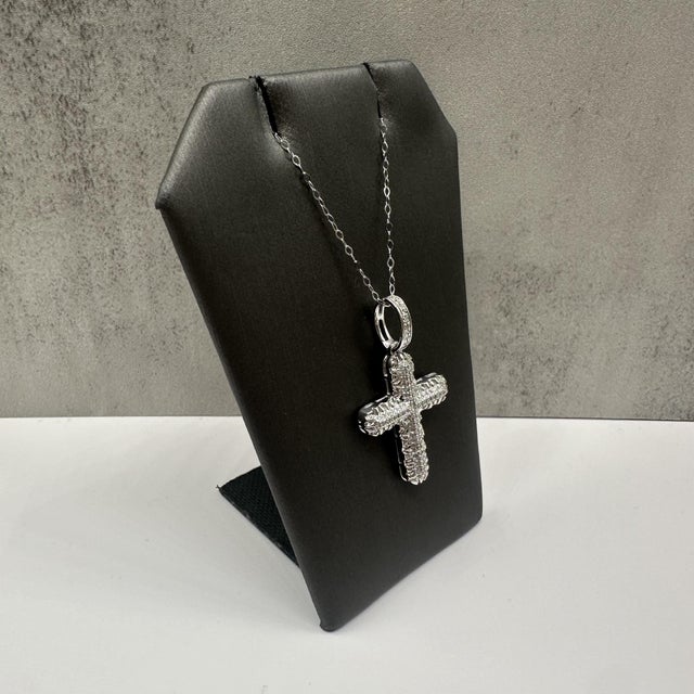 This elegant diamond cross pendant necklace in white gold features 0.24 carats total weight of natural GH SI2–I1 round...