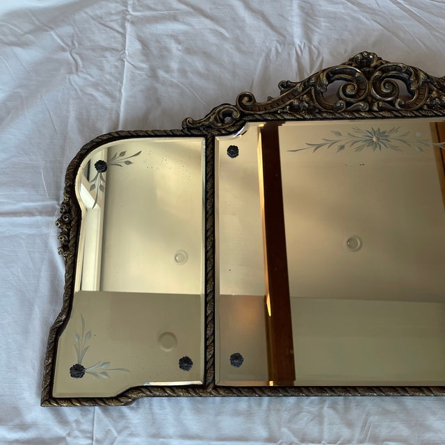 An absolutely amazing gold gilt, gesso frame has etched and beveled mirrors in three panels. I believe it is American done...