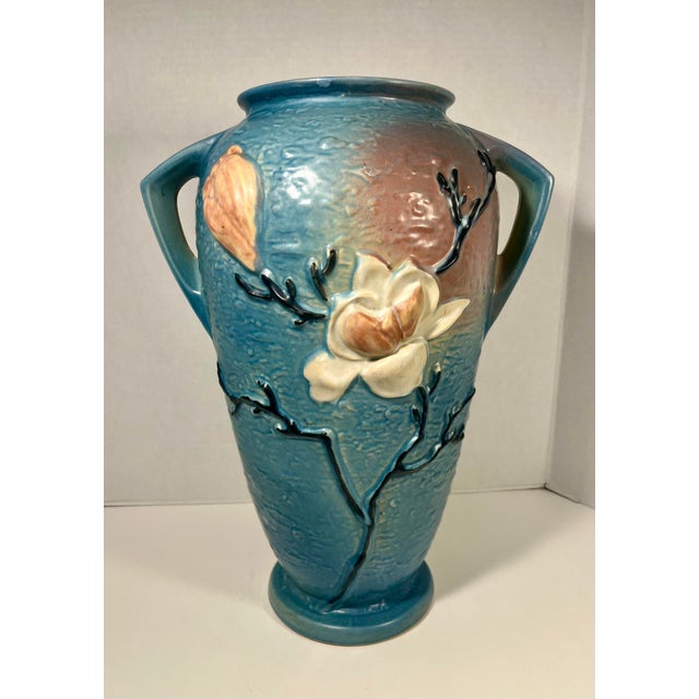 Offered for sale is a stunning and massive vintage Roseville Pottery floor vase featuring the highly sought-after Magnolia...