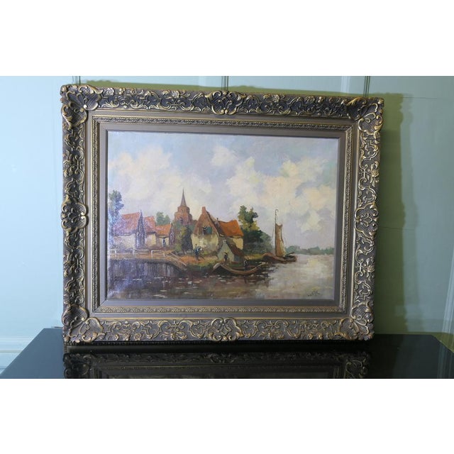 19th Century Oil Painting, signed W.VDijk, Village from the Water The painting is in an elaborate Gilt Frame, the painting...