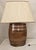 This antique table lamp is crafted from an early stoneware whiskey barrel, later professionally converted for electric...