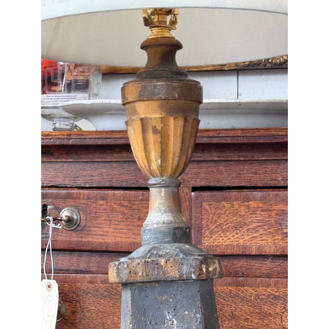Altar stick form lamp with fluted urn standard over a tapered square base with molded edge, raised on carved paw feet....