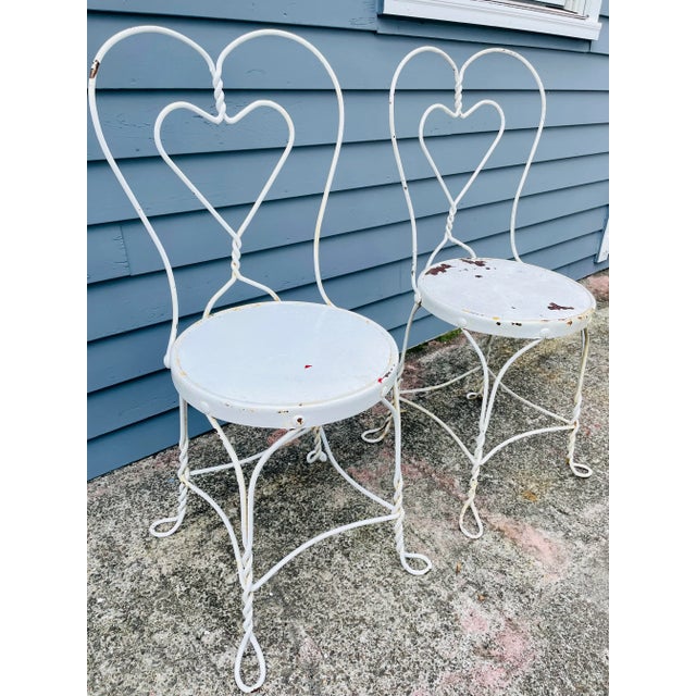 A Pair of Vintage Twisted Iron Heart Back Ice Cream Chairs Perfect for any deck, garden, or patio. Ships for 200 along...
