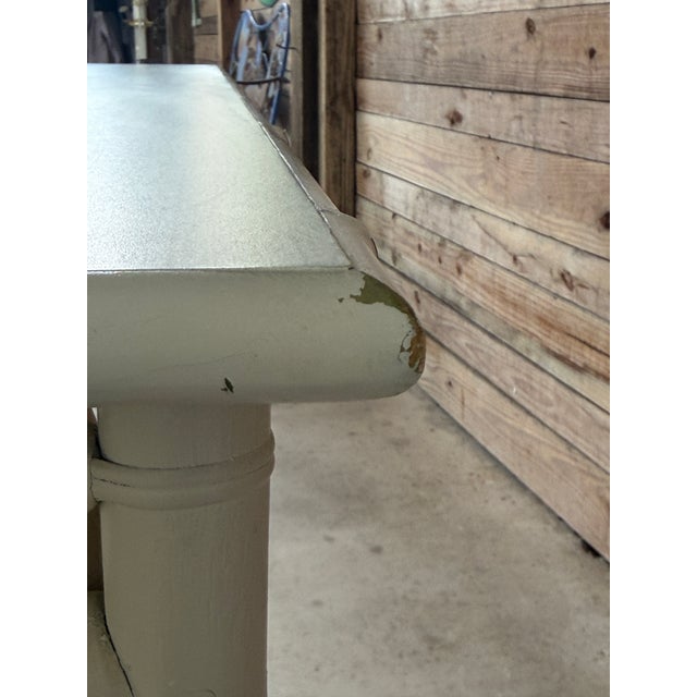 A monumental vintage coastal rattan console table featuring an elongated, narrow profile and classic lattice detailing...